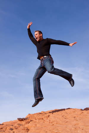 Young casual man jumping in the airの写真素材