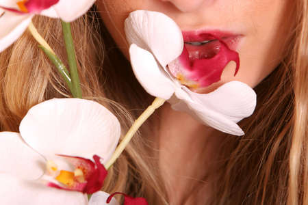 Beautiful young woman with an orchidの写真素材