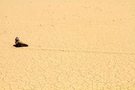 Lonely rock is movig on desert ground in Death Valley Californiaの写真素材