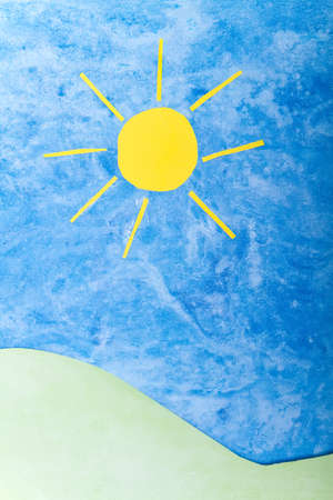Sun, green hills and blue sky handmade from paper for environmental conceptの写真素材
