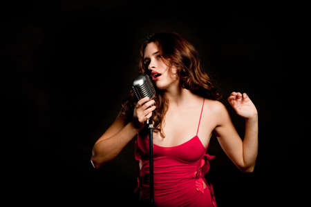 Beautiful singer singing with a retro microphone