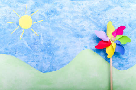 Colorful windmill toy on green environment conceptの写真素材