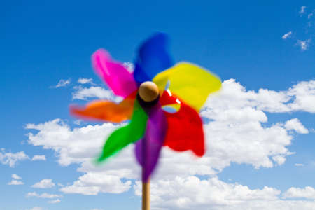 Pinwheel for clean energy concept on blue sky with white cloudsの写真素材