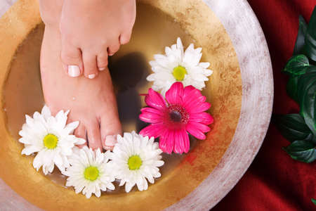 Woman washing her feet in a bowl of waterの写真素材