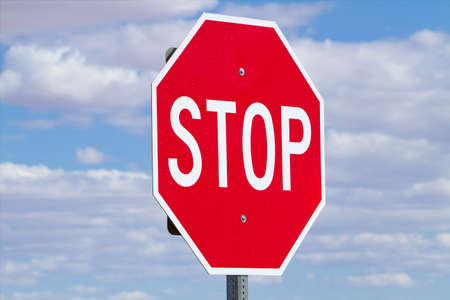 Stop sign against blue skyの写真素材