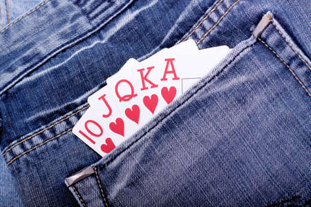 Royal flush with playing cards in blue jeans pocketの写真素材