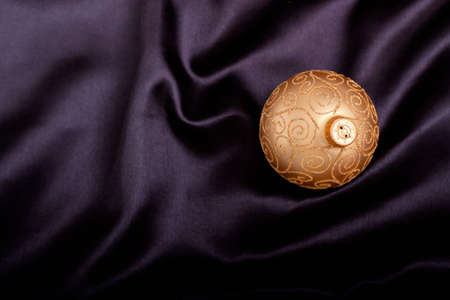 Christmas ornament on black satin materialの写真素材