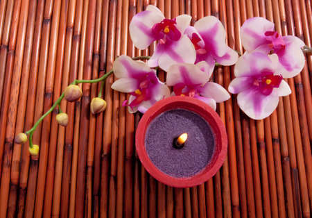 Spa candle and colorful flower for aromatherapy meditationの写真素材