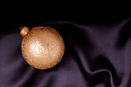 Christmas ornament on black satin materialの写真素材