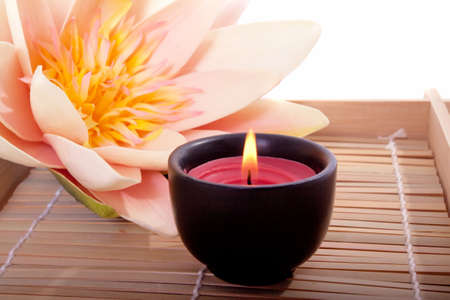 Spa candle and beautiful lotus flower for aromatherapy meditationの写真素材