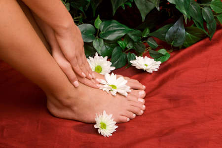 Hand and feet of a womanの写真素材