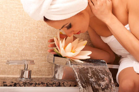 Beautiful young ethnic woman in bathroom の写真素材