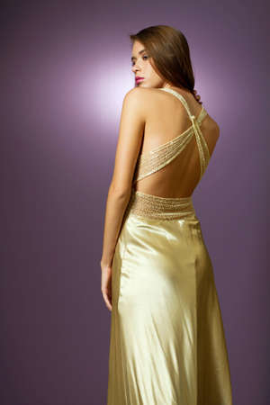 Gorgeous young woman wearing fashion dress studio shotの写真素材