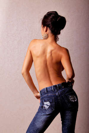 Topless japanese woman wearing blue jeans back shotの写真素材