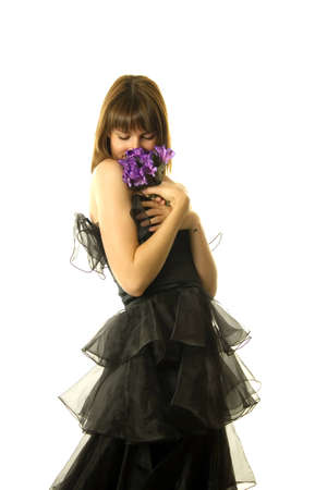 Pretty woman holding a purple flowerの写真素材
