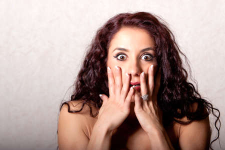 Brunette woman with shocked facial expressionの写真素材