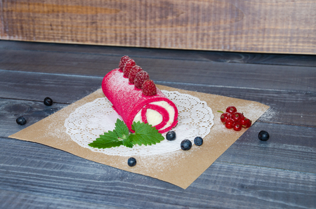 pink cream cheese roll with fresh berriesの写真素材