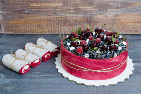 rose wedding biscuit fruit cake with berries and some greenの写真素材