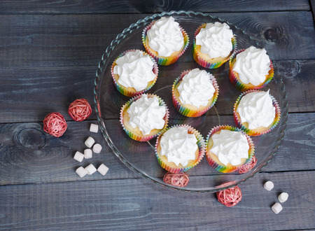 rainbow merengue cupcakes on with rattan decorationの写真素材