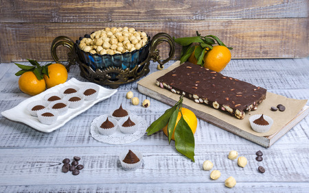 yummy chocolate sweets with hazel nut and tangerinesの写真素材