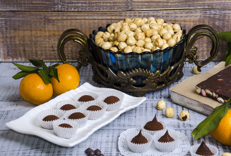 yummy chocolate sweets with hazel nut and tangerinesの写真素材