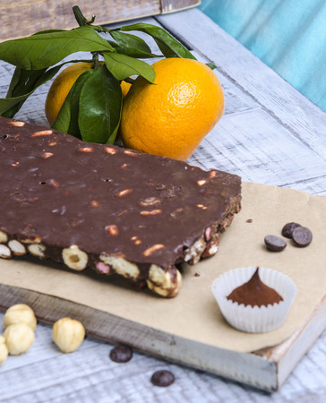 yummy chocolate sweets with hazel nut and tangerinesの写真素材
