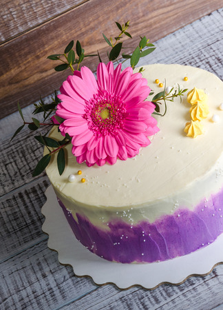 an ombre  cream cheese cake with pink gerbera and eucalyptusの写真素材