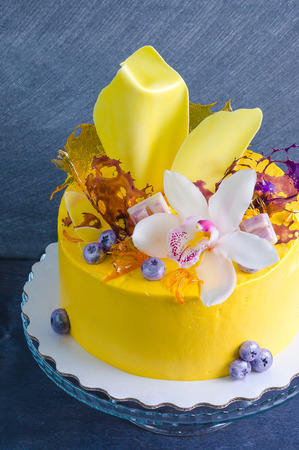 yellow cream cheese cake with chocolate twist and isomalt decorationの写真素材