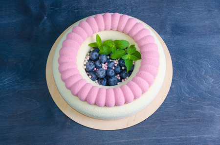 Chocolate velour cake with blueberries and basil leavesの写真素材