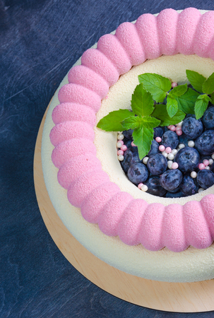 Chocolate velour cake with blueberries and basil leavesの写真素材