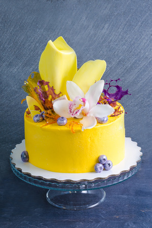 yellow cream cheese cake with chocolate twist and isomalt decorationの写真素材