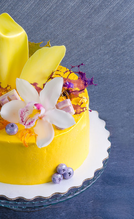 yellow cream cheese cake with chocolate twist and isomalt decorationの写真素材