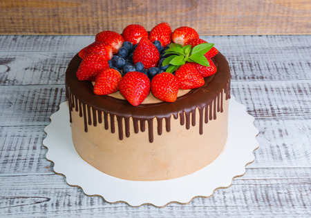 Chocolate drip cake with mint and strawberryの写真素材