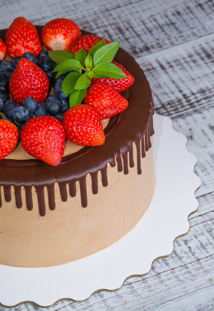 Chocolate drip cake with mint and strawberryの写真素材