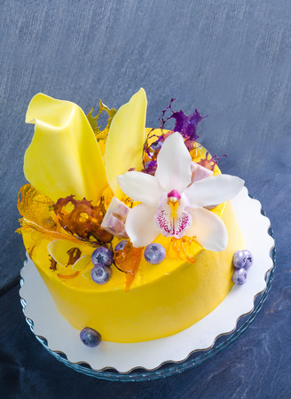 yellow cream cheese cake with chocolate twist and isomalt decorationの写真素材