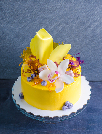 yellow cream cheese cake with chocolate twist and isomalt decorationの写真素材