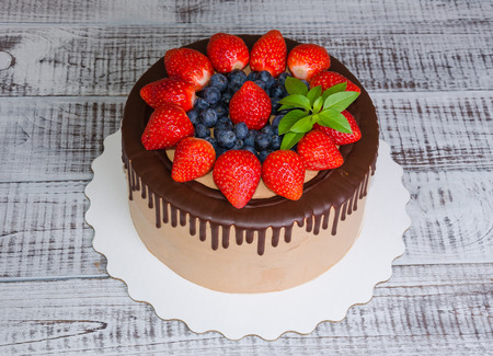 Chocolate drip cake with mint and strawberryの写真素材