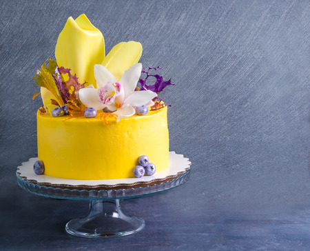 yellow cream cheese cake with chocolate twist and isomalt decorationの写真素材