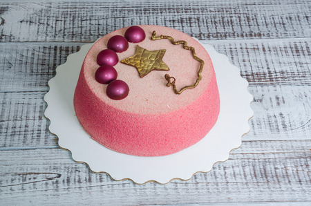 Chocolate velour cake decorated with hemispheres and golden starの写真素材