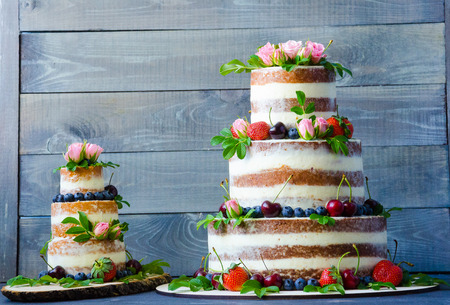 Naked wedding cake decorated with berries and flowersの写真素材