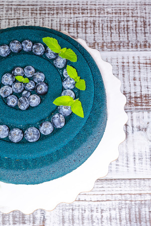 Chocolate velour cake with blueberries and basil leavesの写真素材