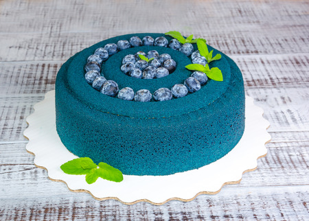 Chocolate velour cake with blueberries and basil leavesの写真素材