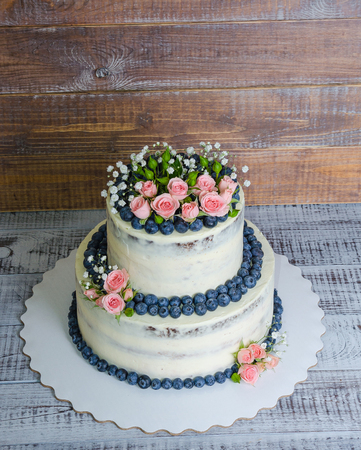 Gentle wedding cake with blueberry and rosesの写真素材