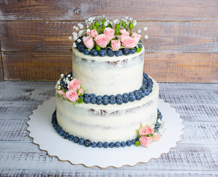 Gentle wedding cake with blueberry and rosesの写真素材