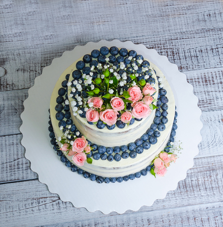 Gentle wedding cake with blueberry and rosesの写真素材