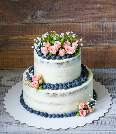Gentle wedding cake with blueberry and rosesの写真素材