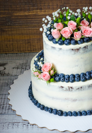 Gentle wedding cake with blueberry and rosesの写真素材