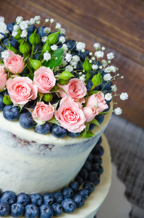 Gentle wedding cake with blueberry and rosesの写真素材