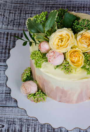 ombre wedding cake decorated with roses and some greeneryの写真素材