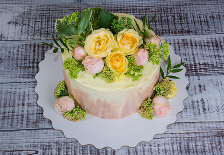 ombre wedding cake decorated with roses and some greeneryの写真素材